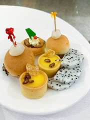 Assorted fusion pastries adorned with dragon fruit evoke whimsical Diwali delicacies and playful Celtic harvest celebrations