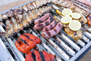 Delicious assorted meats and vegetables grilling on barbecue