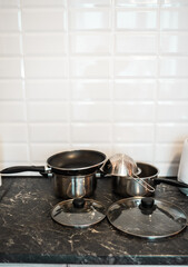 Pots and other kitchenware on a kitchentop. Clean kitchen concept.
