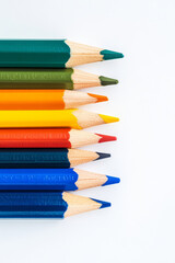 Fototapeta premium Curved Row of Colorful Pencils White Background