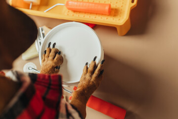 Closeup of dachshund paws on paint bucket, concept dog helping in home DIY work