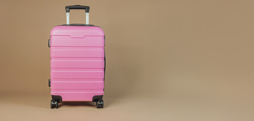 Modern pink suitcase on neutral background, concept travel vacation luggage storage minimalism
