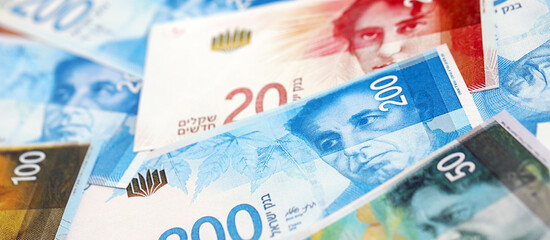 Israel New Shekels banknotes. The current Israel money bills lies on table in big amount