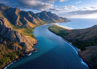 A wide-angle aerial photograph of the Blyde River Canyon in South Africa, overlooking an epic landscape with mountains and a winding river