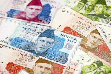 Pakistan rupees banknotes. The current Pakistan money bills lies on table in big amount
