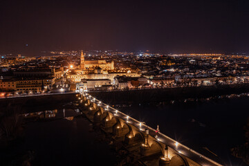 An aerial view showcases the stunning Mosque-Cathedral of Cordoba, with its distinctive bell tower...