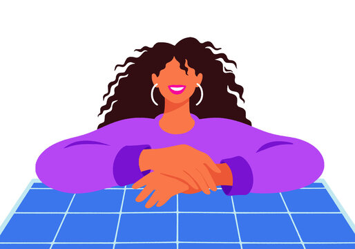 Smiling woman with curly hair rests on blue tiled surface.