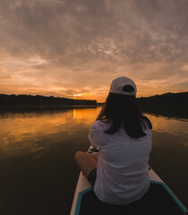 Paddleboarding at Sunset on a Calm Lake