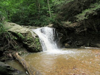 waterfall over rocks in the forest 