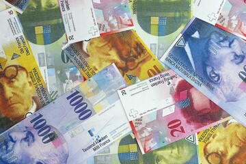 Swiss franc banknotes. The current francs money bills lies on table