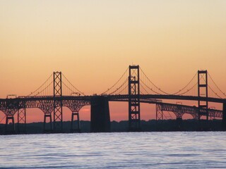 bay bridge at sunset over water