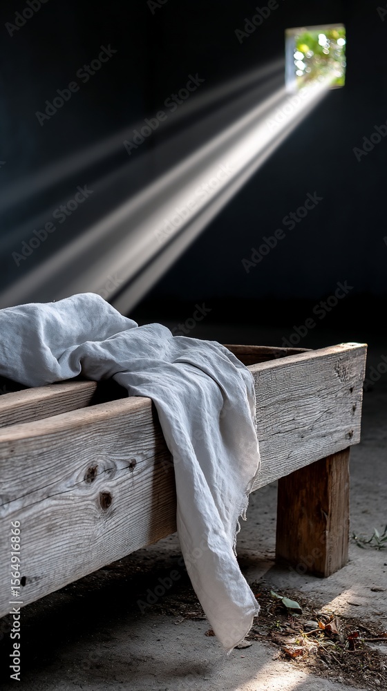 Poster light streams through a window onto a draped cloth on a wooden structure