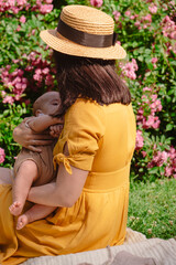 Joyful Mother and Baby in Blooming Garden