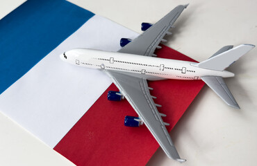 Flag of France and toy airplane . Flight travel concept 