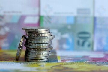 Swiss franc banknotes and coins. The current francs money bills and coins lies in big amount