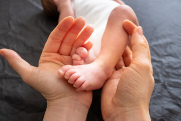 Tender Moment: Adult Hands Holding Newborn Baby Feet