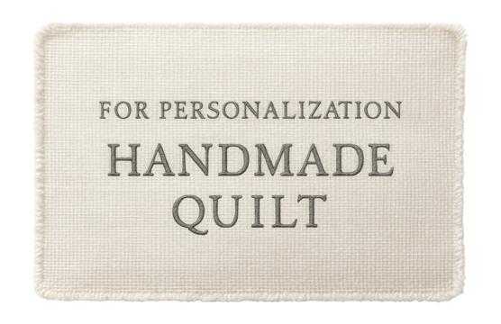 A fabric label with embroidered text, typically sewn onto handmade quilts for personalization.