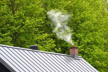 smoke coming out of a brick chimney