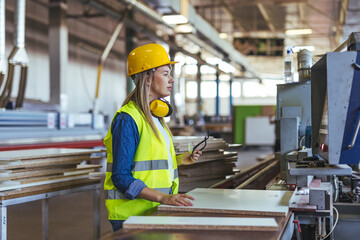 Female Worker Operating Machinery in a Modern Industrial Factory Setting