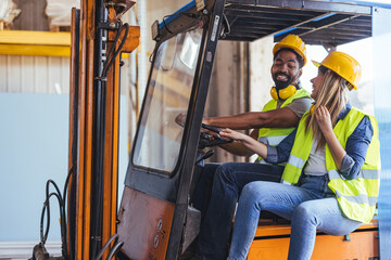 Two Workers Interacting and Smiling Inside Industrial Forklift at Warehouse