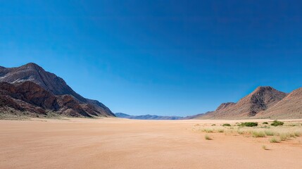 Naklejka premium Vast Desert Landscape with Mountains under Clear Blue Sky