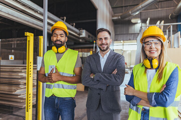 Group of Factory Workers and Manager Collaborating in an Industrial Environment