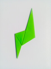 Green lightning origami isolated on white background.