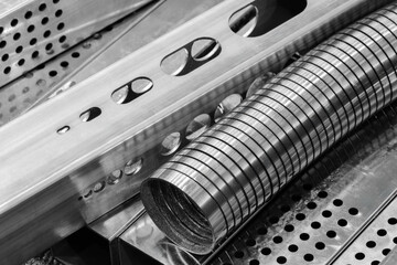 Various metal parts on the table in the factory. Industrial metalworking concept background.