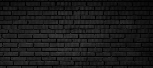 Black brick wall with no visible design. The wall is made of bricks and is very dark