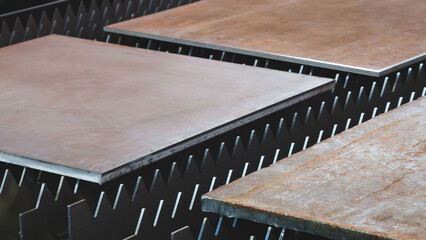 A brownish colored metal sheet is placed on the surface. plate is made of metal and has a rough...