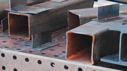 A pile of rusty metal parts, including cut pipes and elbows, the scene represents one of decay and...