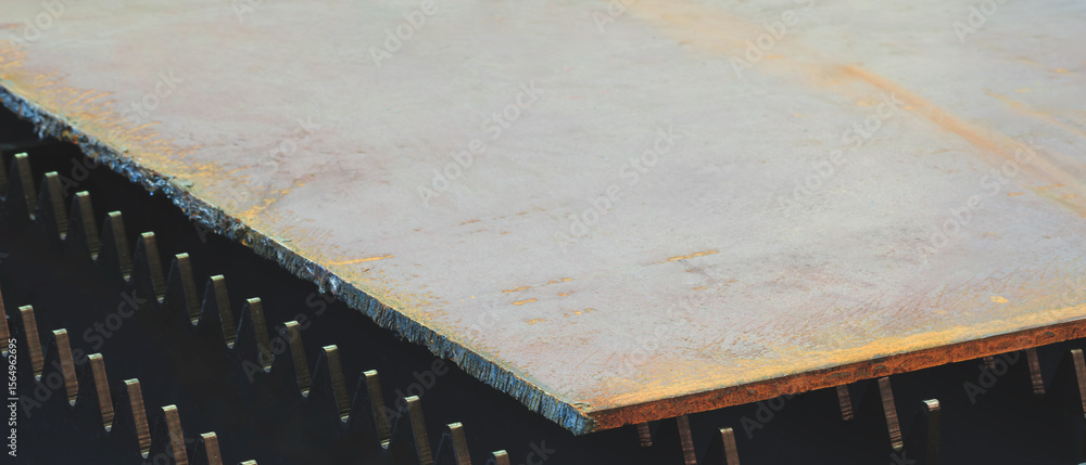 Poster a brownish colored metal sheet is placed on the surface. the plate is made of metal and has a rough 