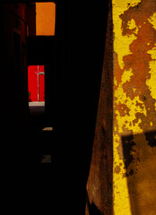 Vivid urban alleyway with bold color contrasts and strong light reflection