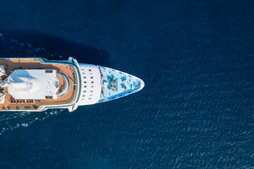 Aerial top down view of a generic cruise ship sailing over blue ocean as a travel concept with copy...