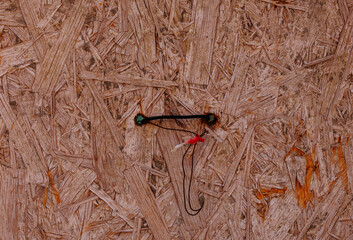 Osb board texture with red and black string detailing
