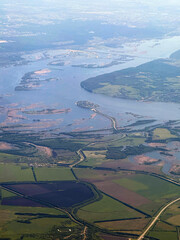 Flooding of the Sviyaga River, green fields and the island town of Sviyazhsk from a bird's eye view, aerial photo
