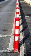 Red and White Bollards Lining a City Street