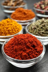 Different aromatic spices on grey table, closeup