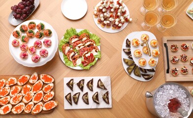 Buffet menu. Many different appetizers on wooden table, flat lay