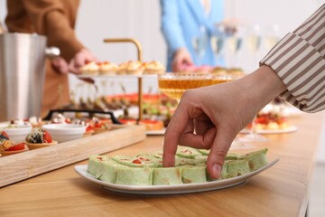 People with different appetizers at buffet, selective focus