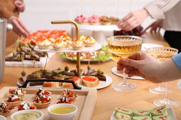 People with different appetizers at buffet, selective focus