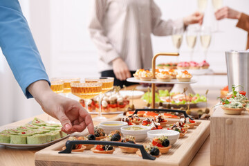 People with different appetizers at buffet, selective focus