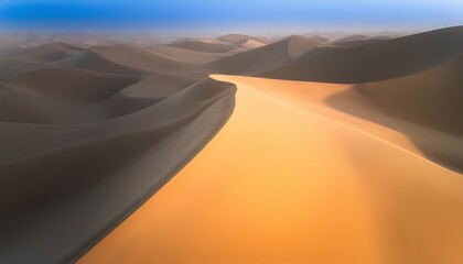 Golden sand dunes under clear blue sky in serene desert