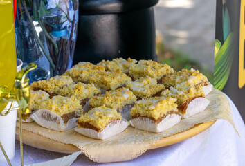 Traditional homemade crumb cake with icing, cut into individual portions and served in paper liners...