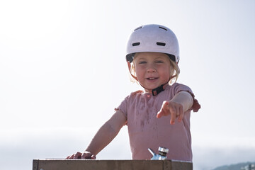 Girl in a Bike Helmet Drinking Water Because of the Heat
