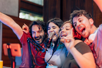 Podcasters having fun recording a live show in studio