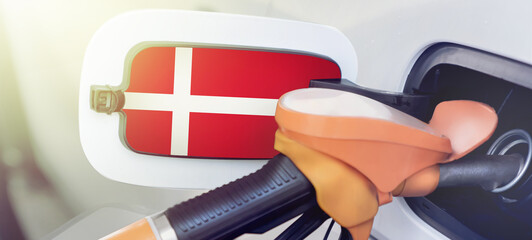 The flag of the Kingdom of Denmark on the lid of the gas tank of a car at a gas station in...