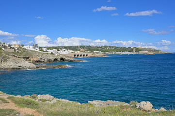 View from the coast by Punta Ristola to Santa Maria di Leuca against sunny sky. Apulia, South Italy.