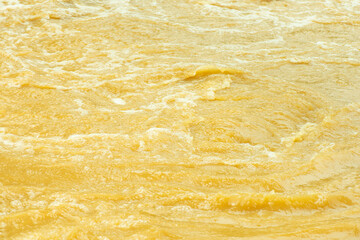 Orange water with ripples on the surface. Defocus blurred transparent blue colored clear calm water...
