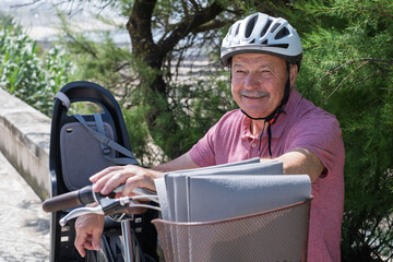 Elderly Man in a Bike Helmet Resting After a Ride